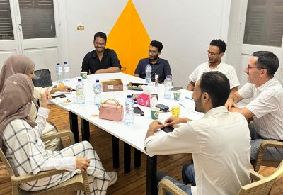 Group meeting around a table in Sarai workspace